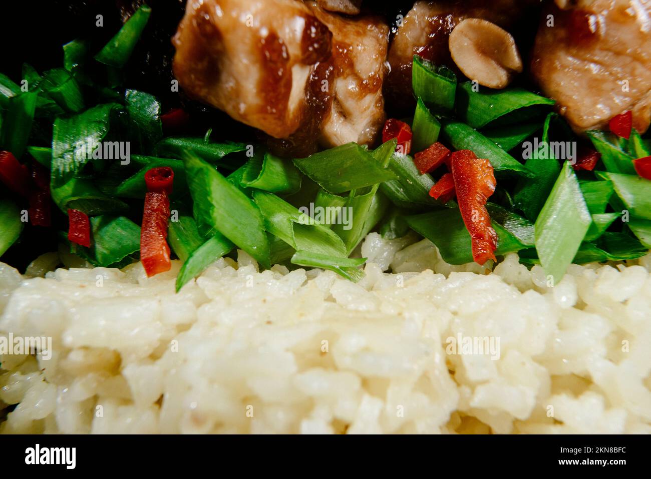 Asian food. Macro. Asianstyle kung pao chicken with rice and green