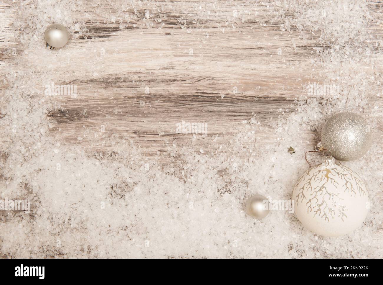 Christmas Wooden gray background with artificial snow and silver Christmas decorations Stock Photo