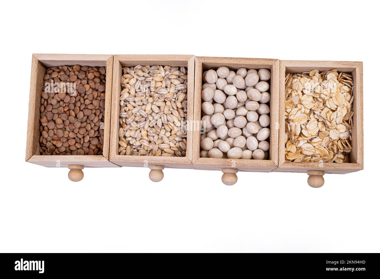 Pattern of raw cereals, beans and seeds, top view texture, mix of groats in square wooden box. Small wooden box with cells with beans lentils oatmeal Stock Photo