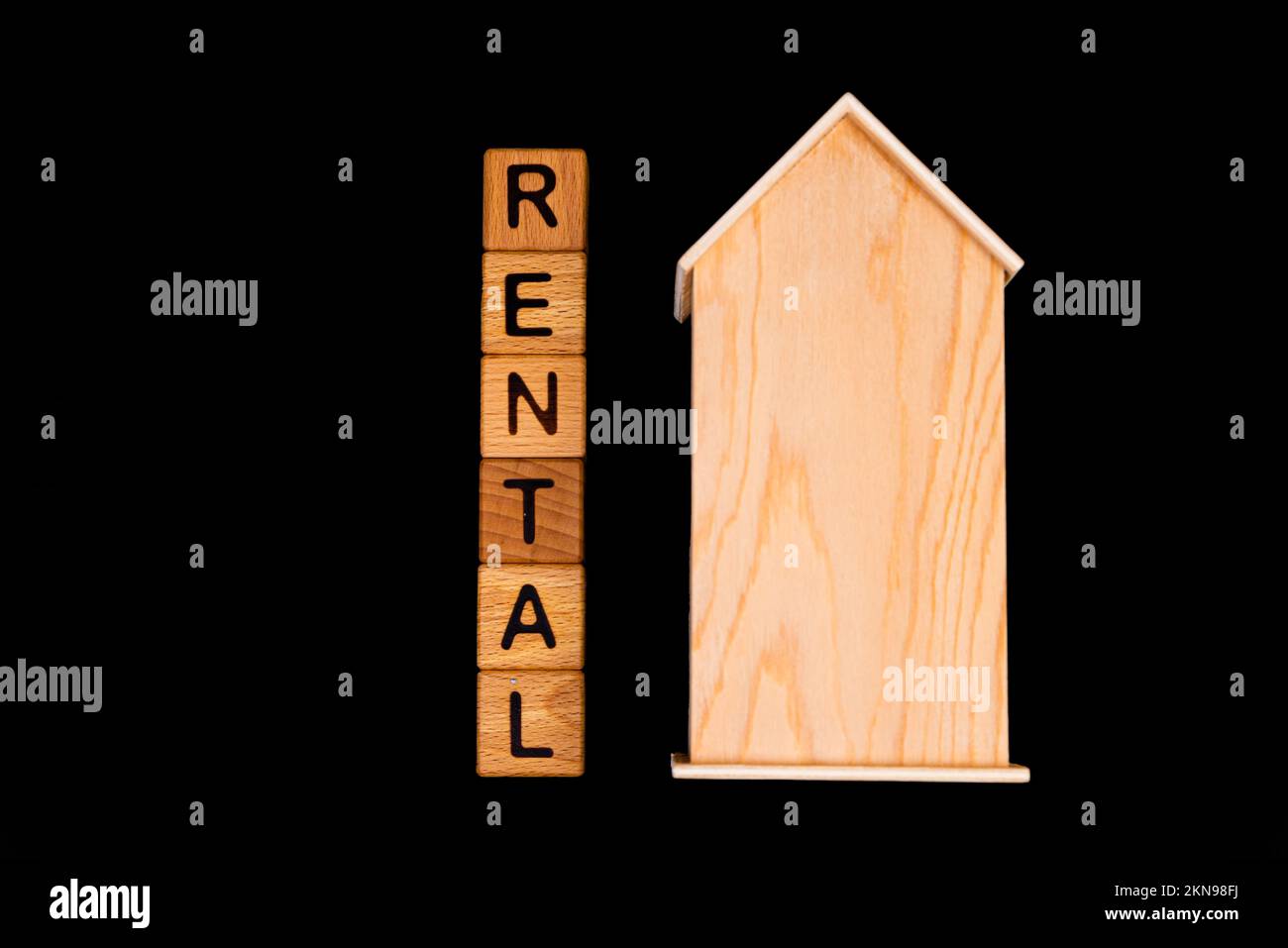 wooden house mockup with house keys, wooden cubes with words rent sale , buy and loan. Project