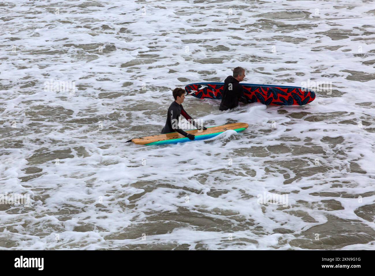 Bournemouth, Dorset UK. 27th November 2022. UK weather: high tides and big waves as surfers head to Bournemouth beach to make the most of the conditions surfing in the sea. Credit: Carolyn Jenkins/Alamy Live News Stock Photo