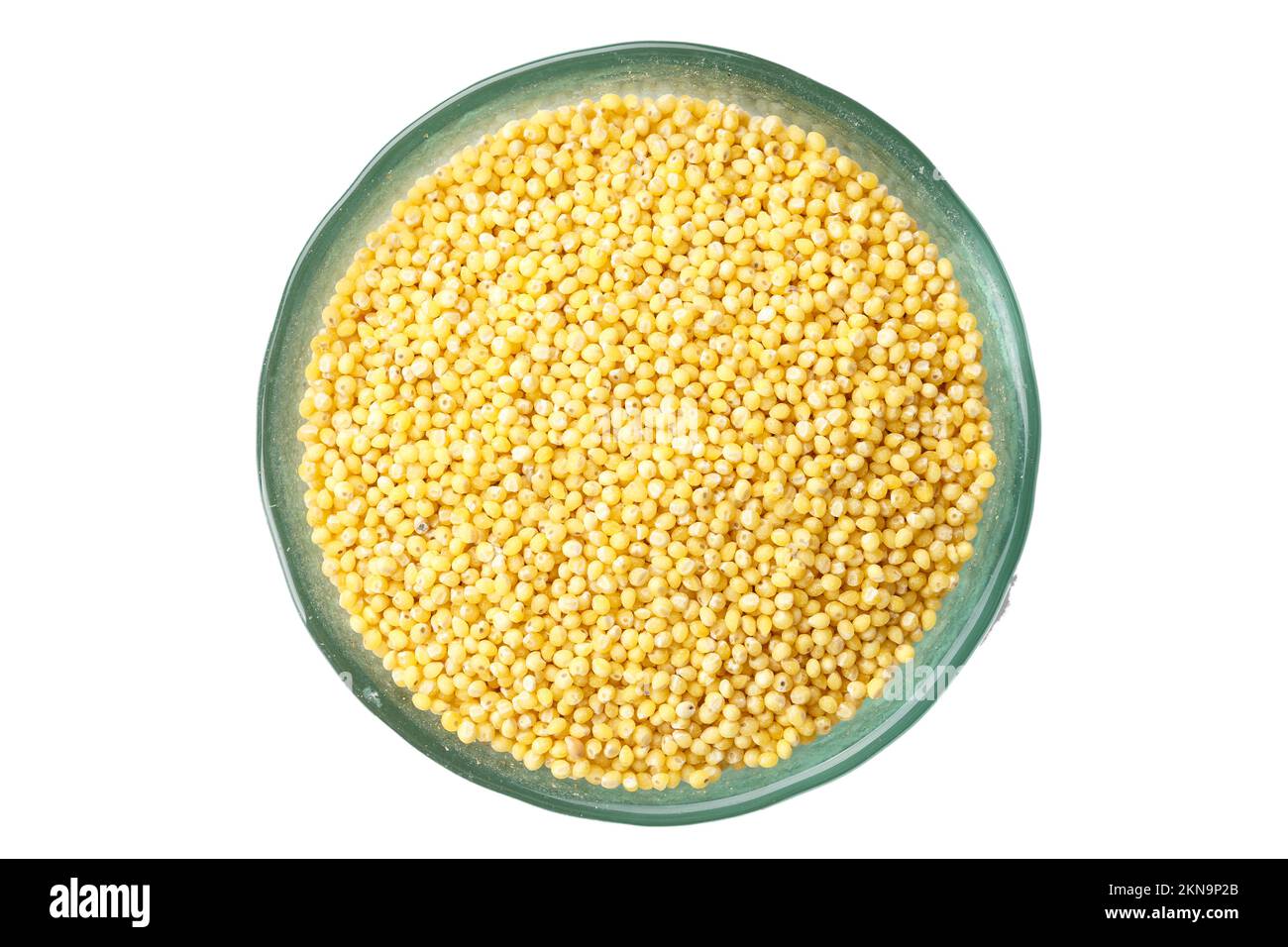 raw millet cereal in a plate on a white background, isolated Stock