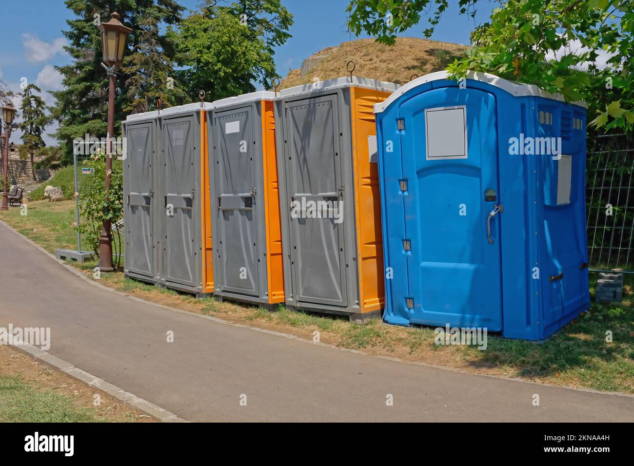 Temporary toilets cabins wc in city park summer festival Stock Photo