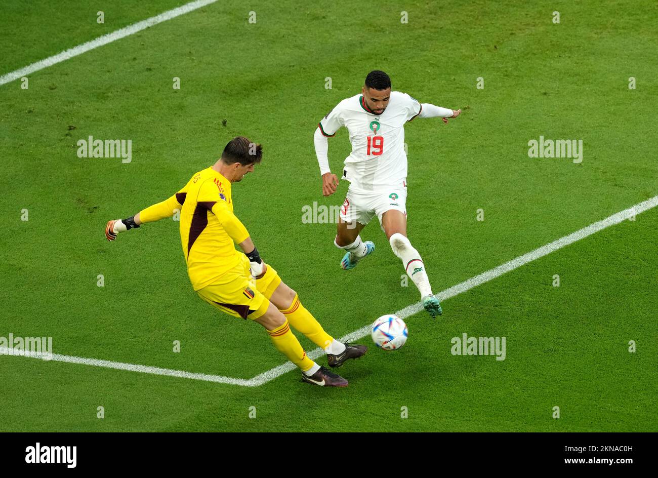 Belgium goalkeeper Thibaut Courtois clears under pressure from Morocco's Youssef En-Nesyri (right) during the FIFA World Cup Group F match at the Al Thumama Stadium, Doha, Qatar. Picture date: Sunday November 27, 2022. Stock Photo