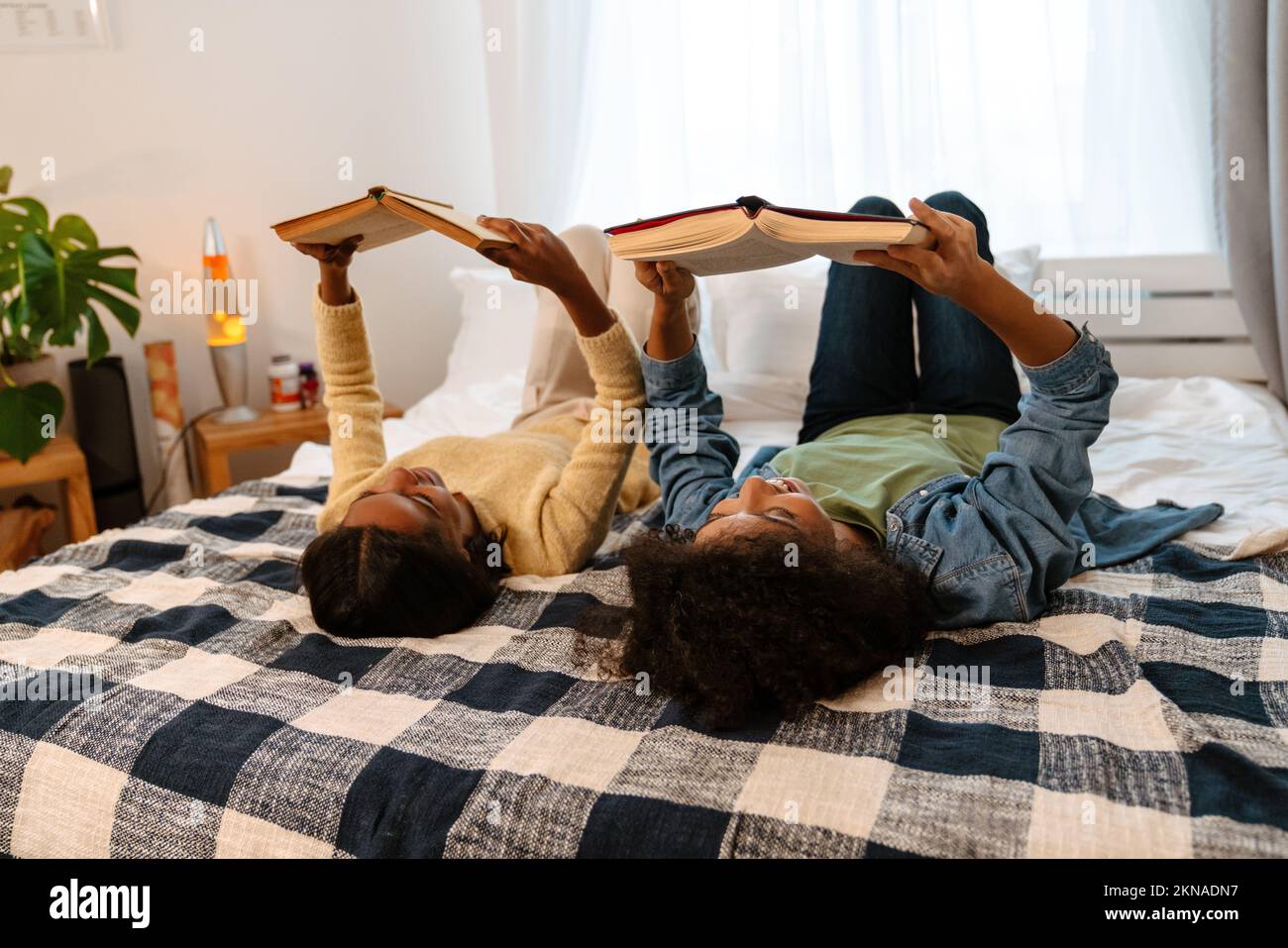 Black girl lying on books hi-res stock photography and images - Alamy