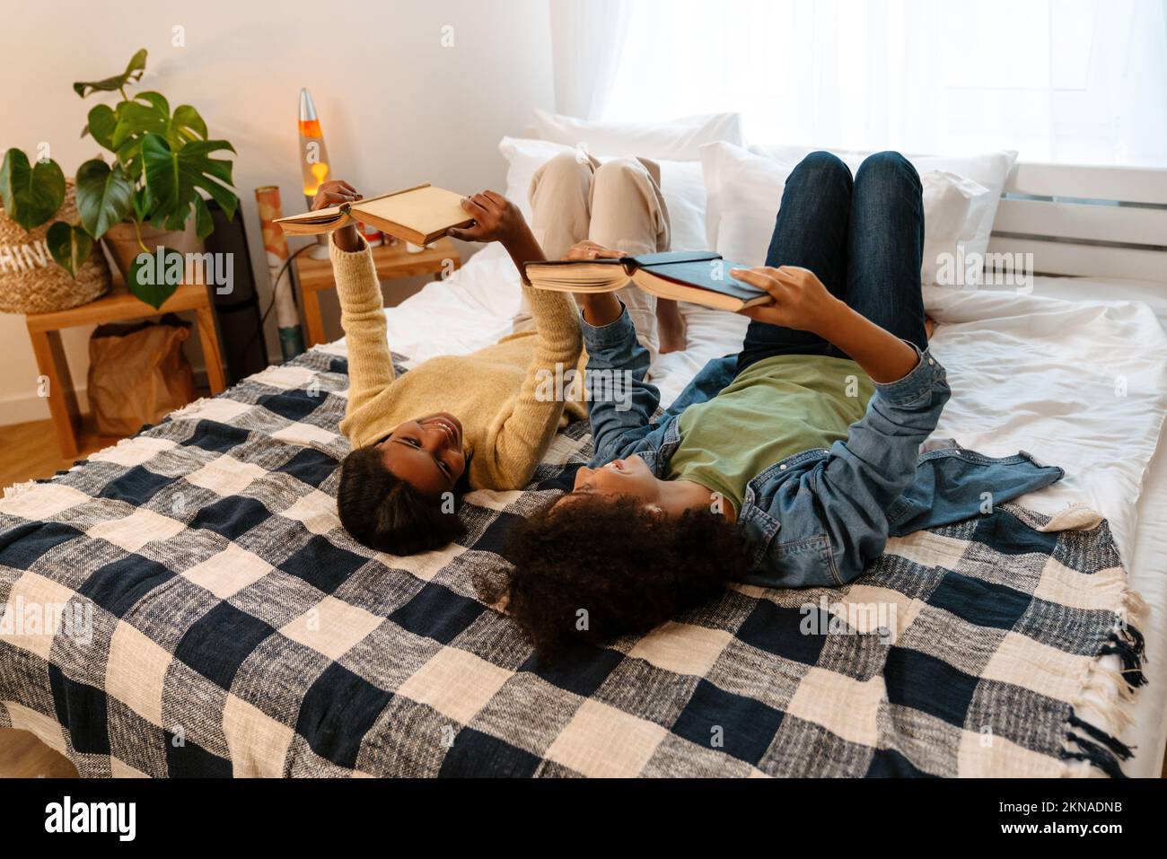 Black girl lying on books hi-res stock photography and images - Alamy