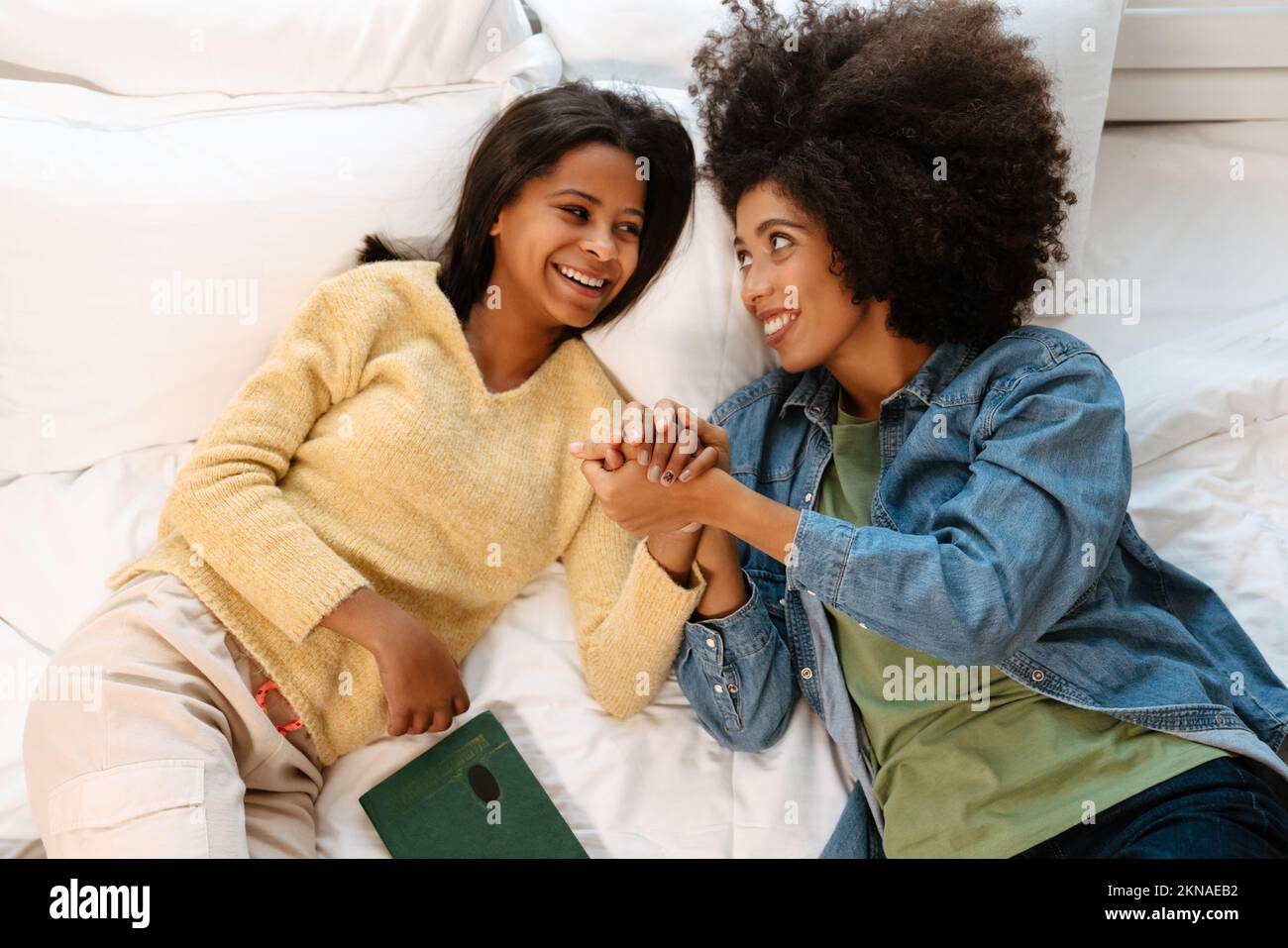 Girl lying on bed holding hi-res stock photography and images - Alamy