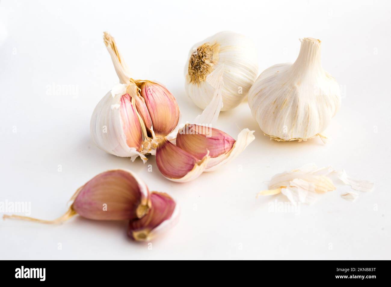 garlic heads and cloves on white background Stock Photo - Alamy