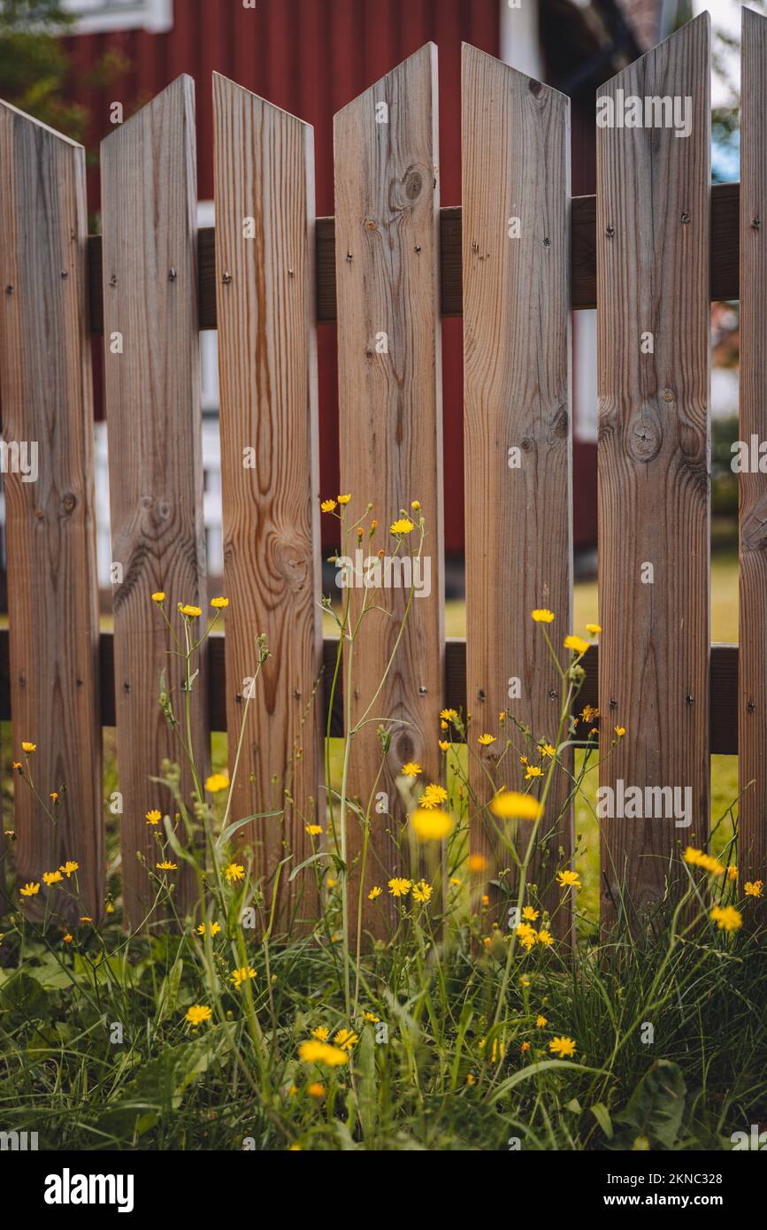 A vertical shot of a rural wooden fence in a garden in Sweden Stock ...
