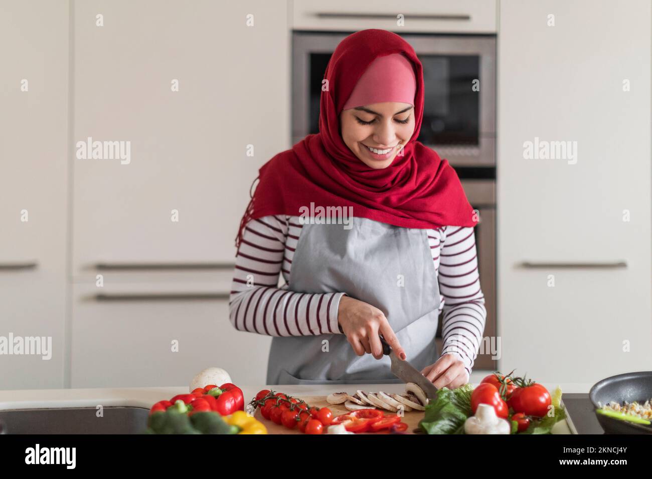 Cheerful Middle Eastern Muslim Woman Preparing Healthy Meal At Home Photo Inspiration