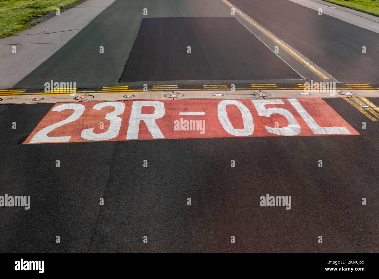 markings on airport taxiway at entrance to runway Stock Photo Alamy