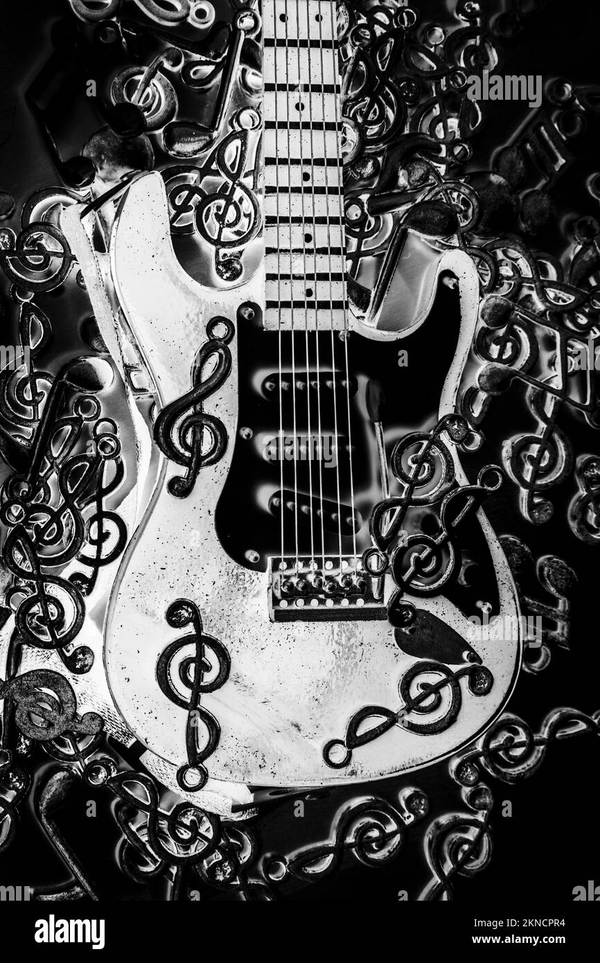 Black and white instrumental in guitars and metal notation in abstract composition Stock Photo
