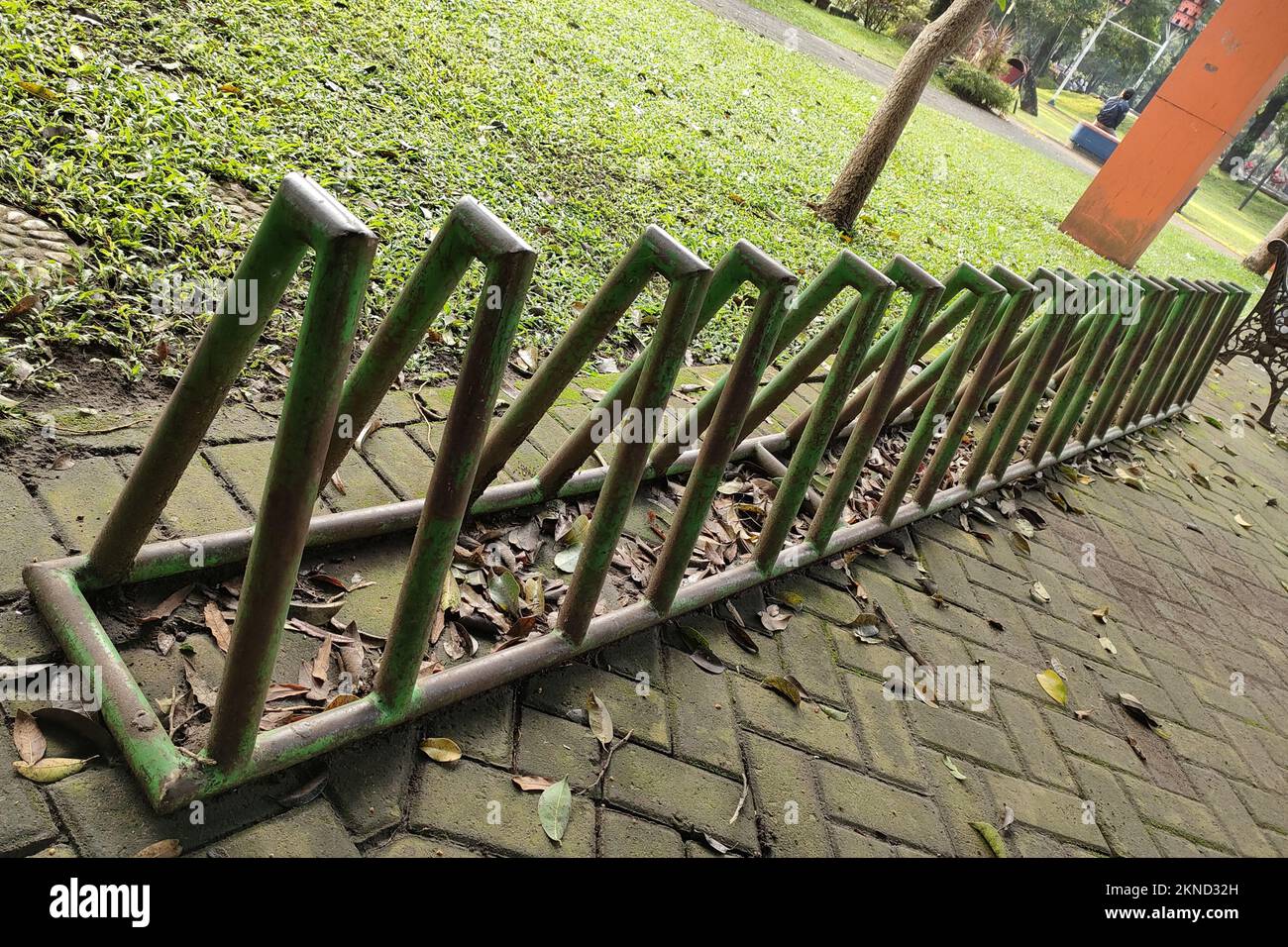 Bicycle parking lot in the park that is placed on a footpath made of paving block Stock Photo