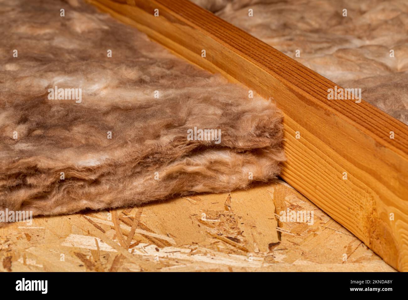 Fiberglass insulation in attic of house. Home energy savings, heating and cooling costs and construction concept. Stock Photo