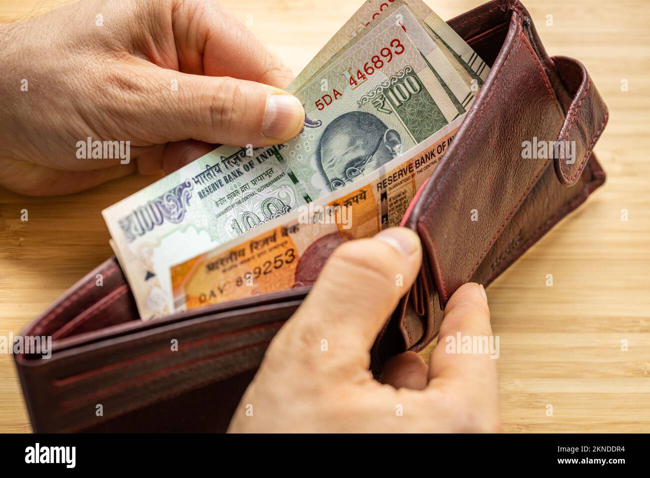 Hand takes out money from wallet, India Banknotes, Economic concept