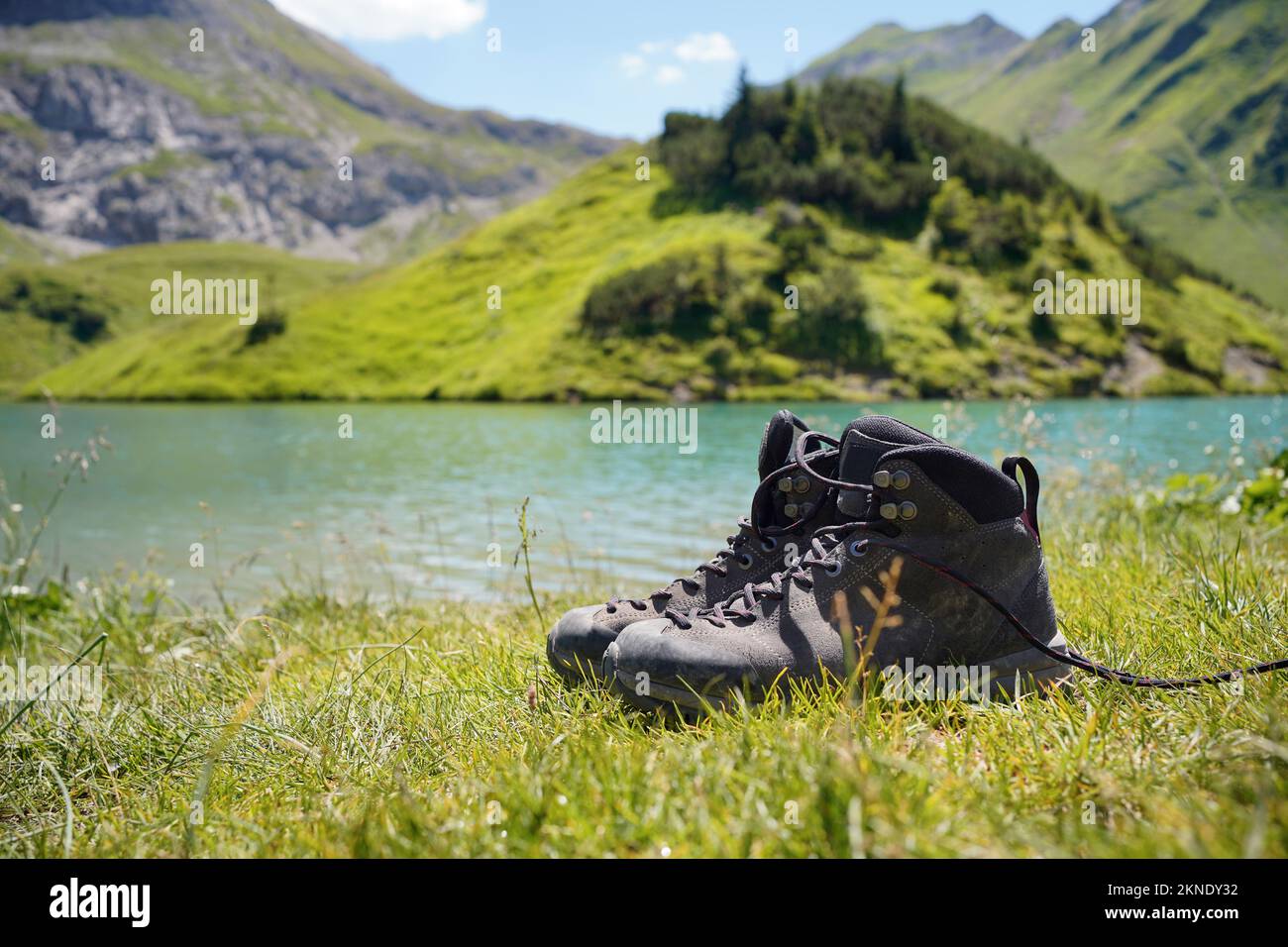 Pair of hiking boots at mountain lake 'Schrecksee' in the german alps. Stock Photo