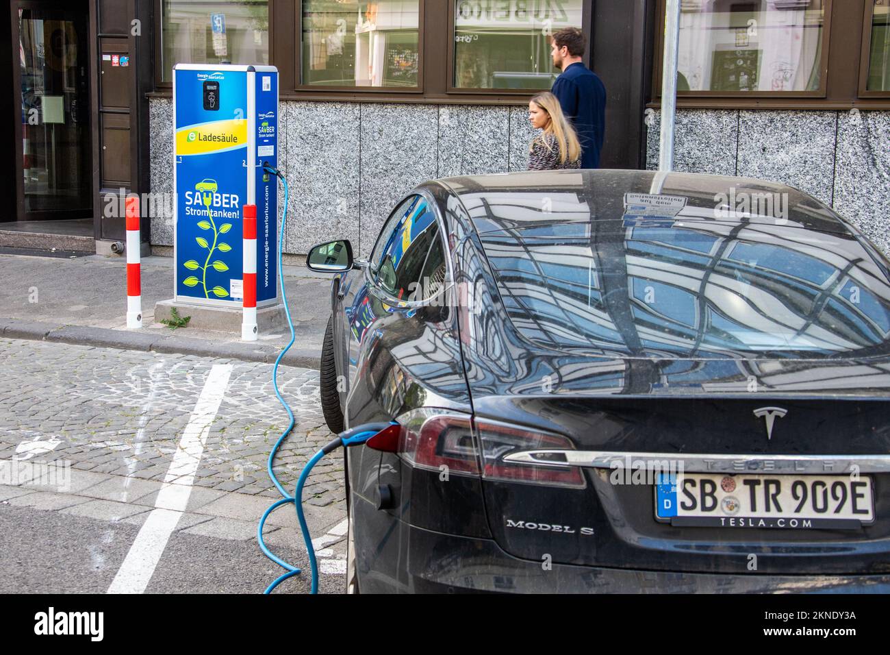 Tesla charging at a Ladesaule EV electric vehicle charger, Saarbruck, Germany Stock Photo