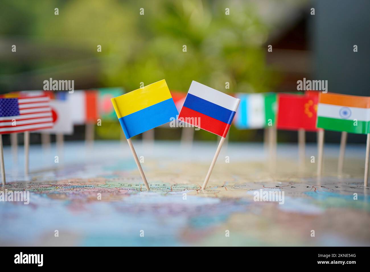 Ukrainian and Russian flag in the centre of a map surrounded by flags of ohter nations. Stock Photo