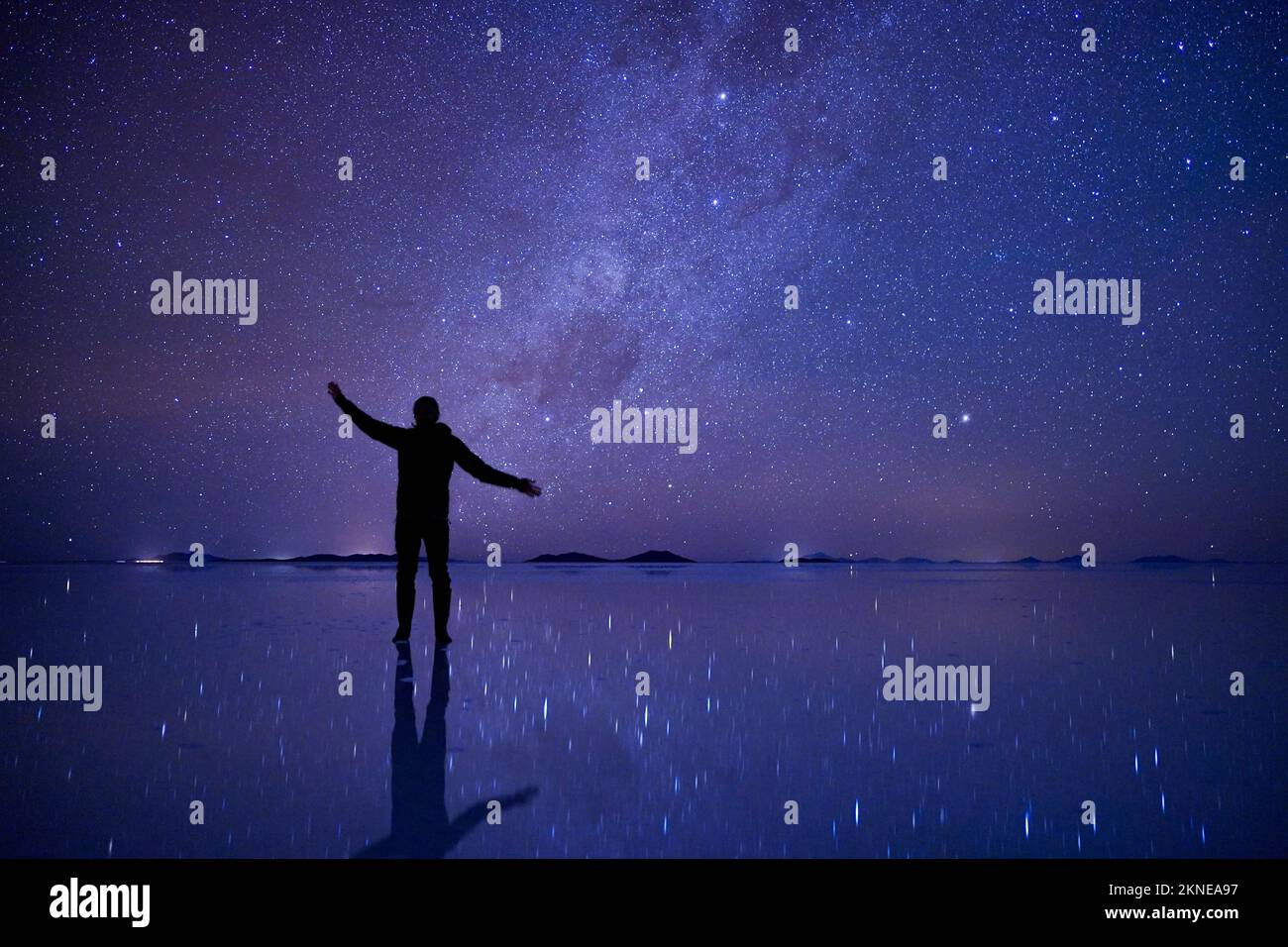 Night star sky at Uyuni salt flats, Bolivia, with a silhouette person