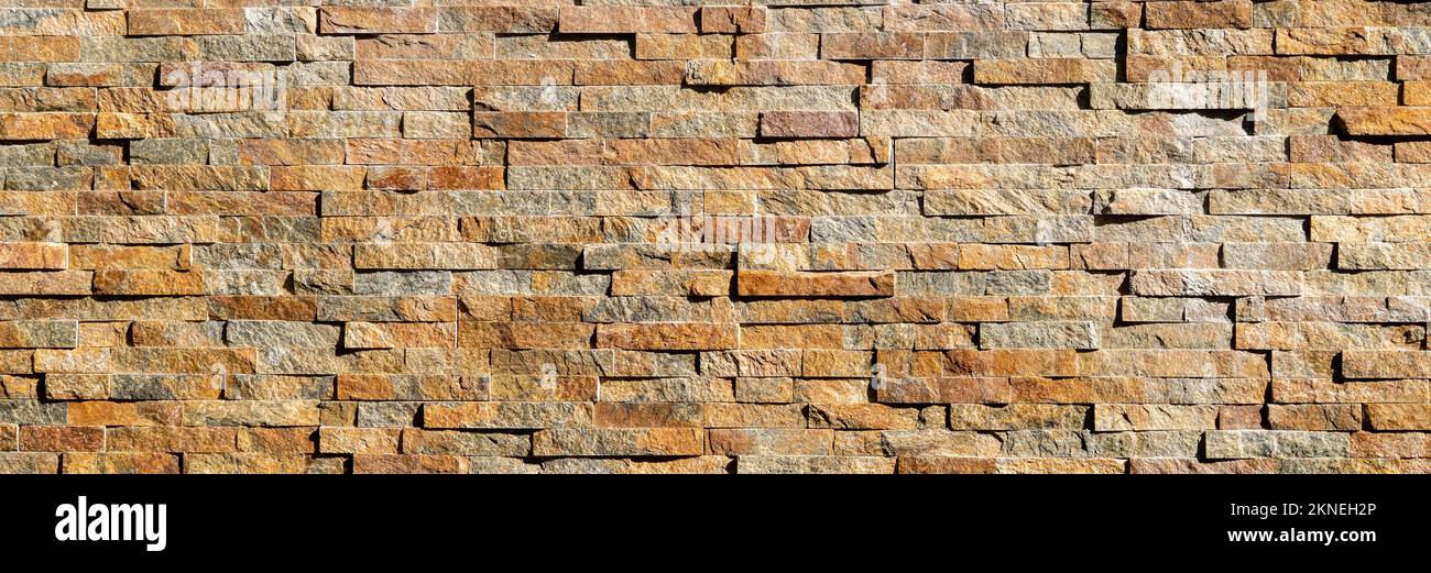 Decorative stone wall background pattern. Brown modern seamless brick