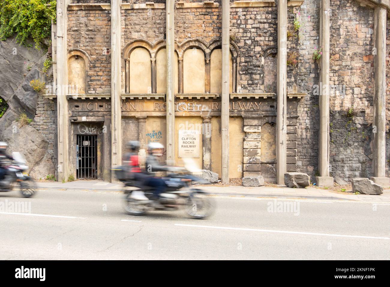 motorbike speeds past abandoned entrance Clifton Rocks railway near bristol uk Stock Photo