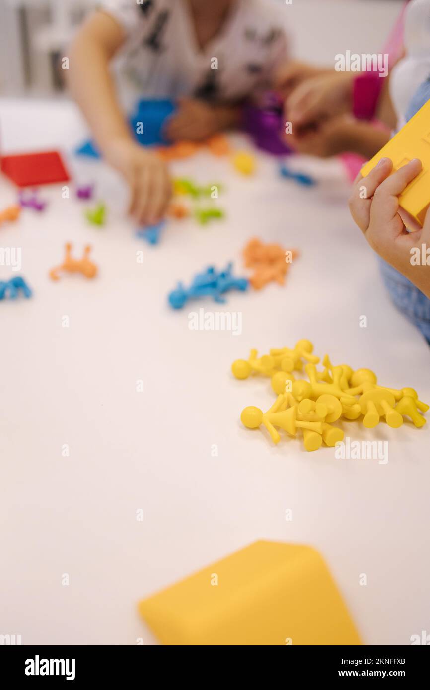 Close-up children play with toy monkey. Different color of toys. Education for little kids Stock Photo