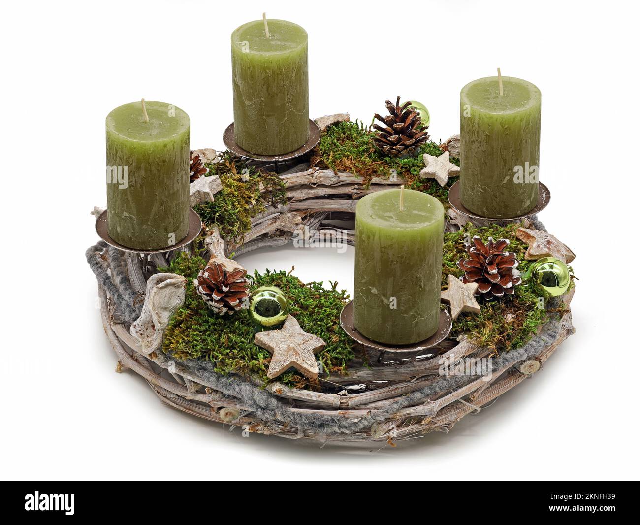 Wooden advent wreath with green candles, christmas balls moss and stars isolated on white background Stock Photo