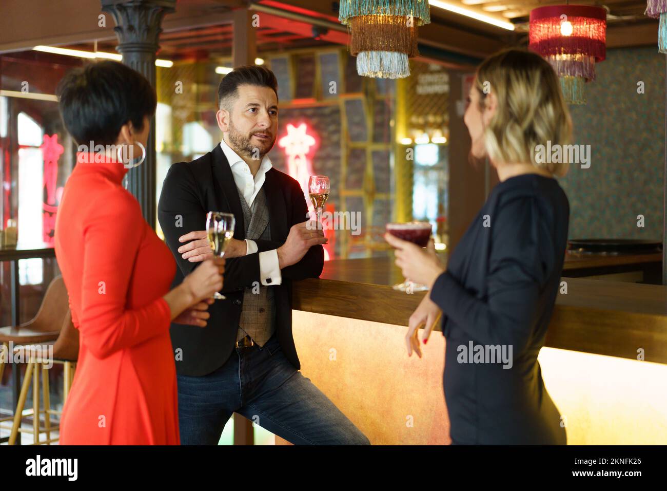 Company of friends drinking champagne in bar Stock Photo