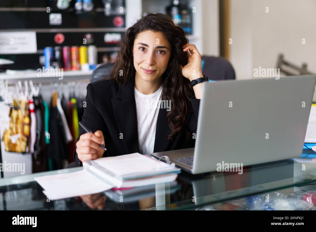 Glad sports psychologist touching hair during work Stock Photo