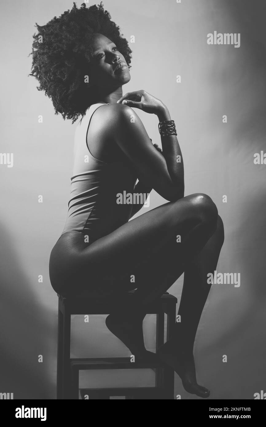 Black and white photograph of sensual black woman under neon light Stock Photo