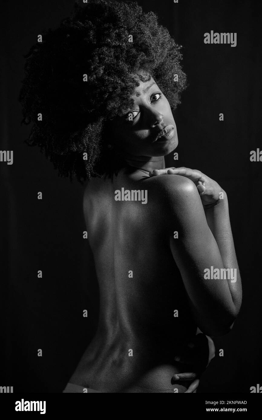 Black and white photograph of naked black woman under neon light Stock Photo