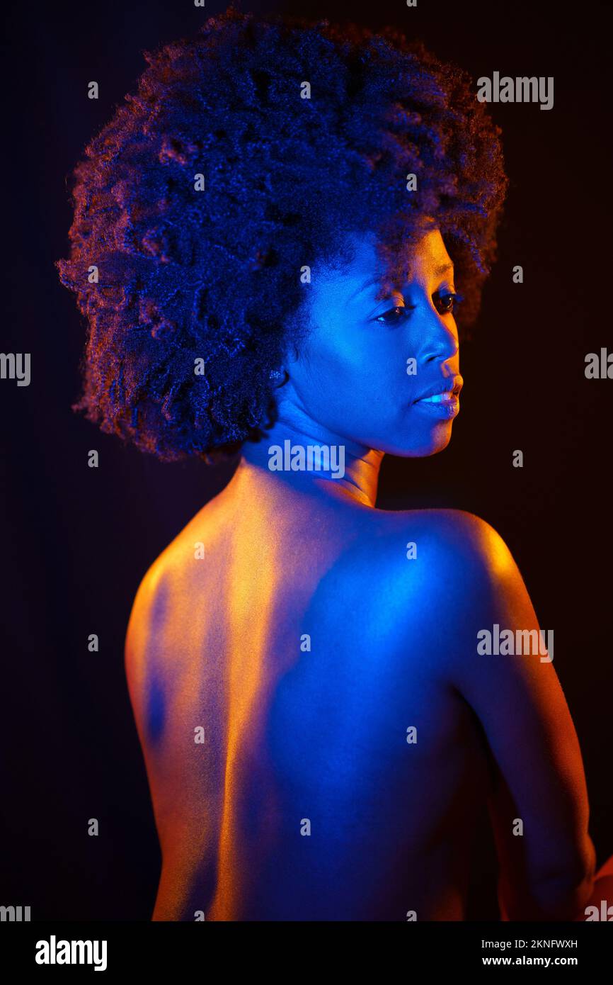 Naked black woman under neon light Stock Photo