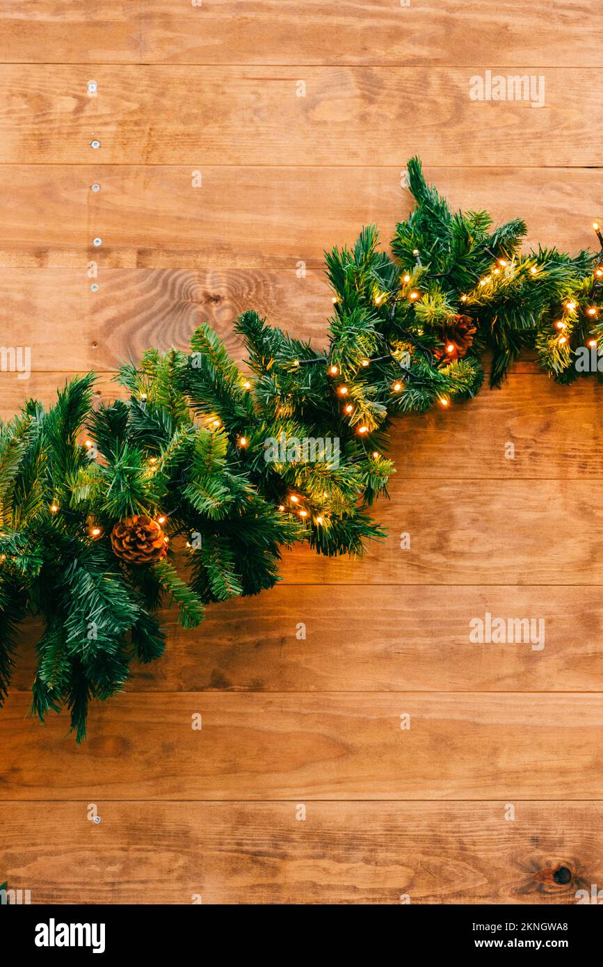 Christmas fir tree with lights on wooden background with copy space Stock Photo