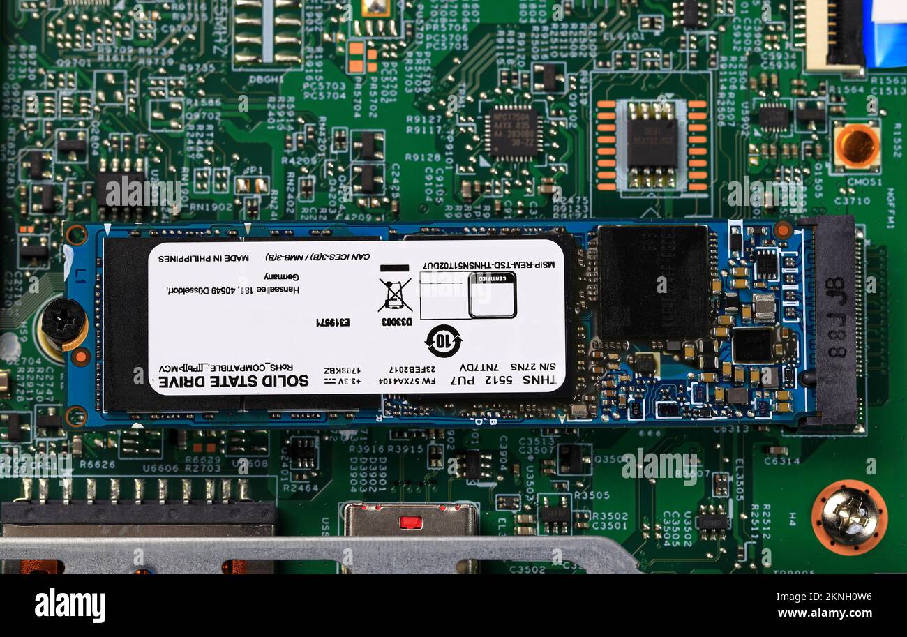 The blue SSD PCle NVMe M.2 on green motherboard background Stock Photo