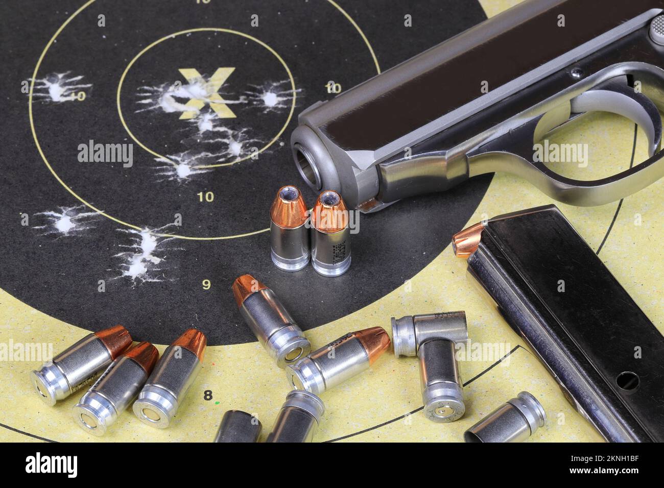 Gun and shooting target With Bullet Holes, bullets and shells or cartridge. Classic Paper Shooting Target. Stock Photo