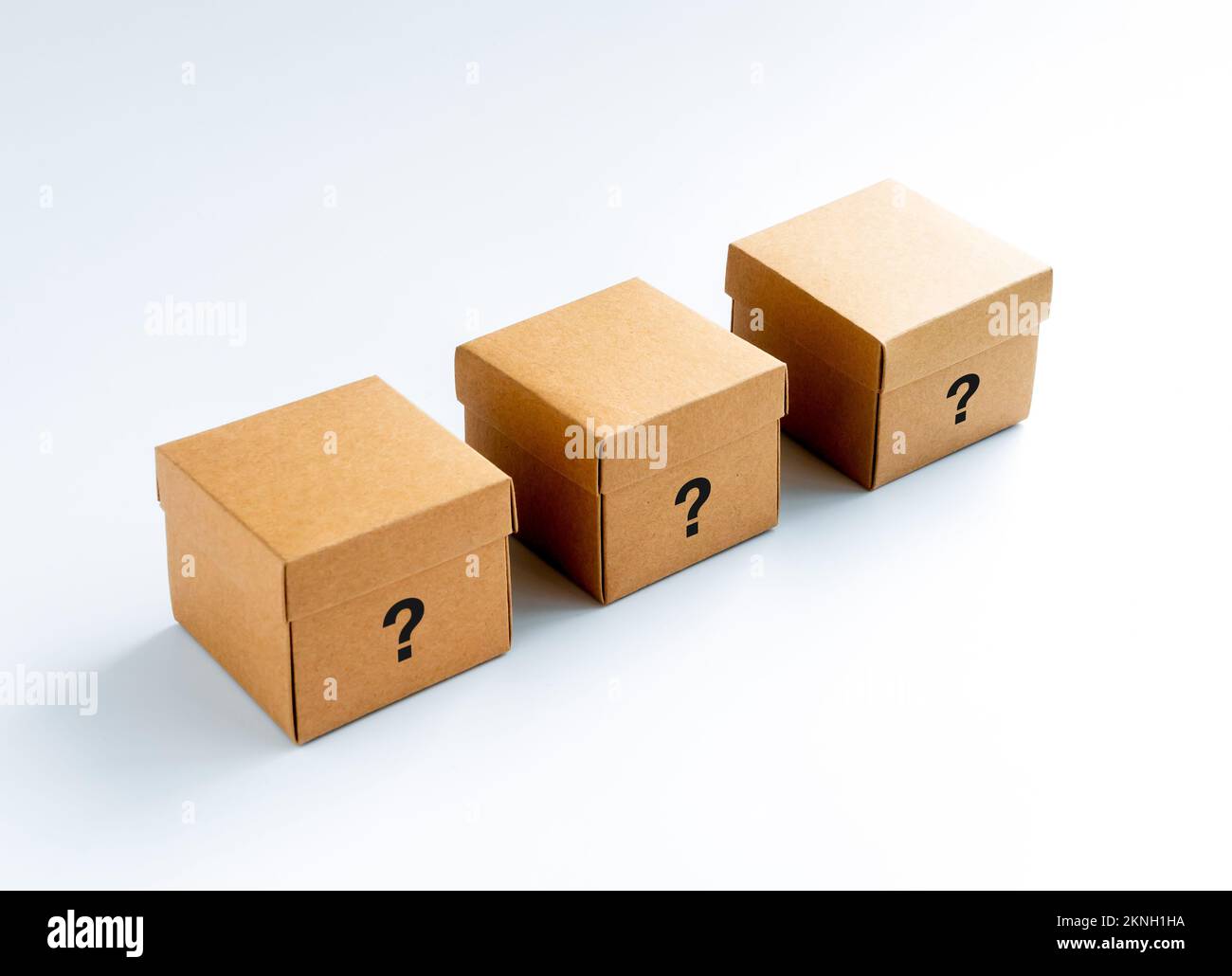 Question mark character icon on three closed cardboard boxes isolated