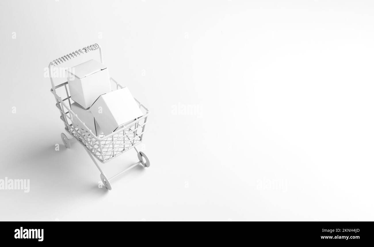 Shopping online business, e-commerce, delivery, purchasing power concepts. White parcel boxes in shopping trolley cart supermarket isolated on white b Stock Photo