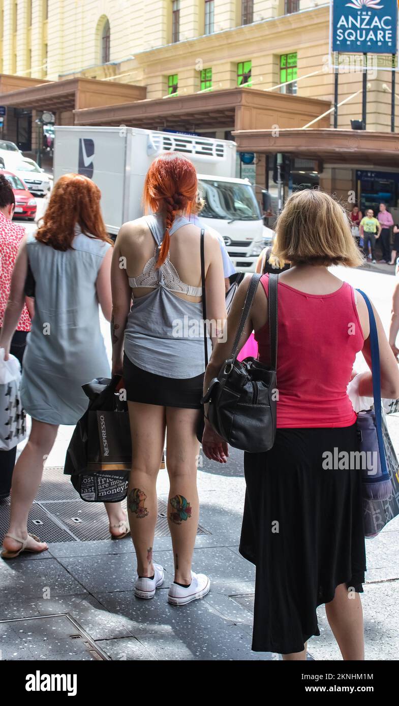 2-4-2015 Brisbane Australia - Backs of women shoppers with all their bags waiting for the crosswalk in near Anzac Square Stock Photo