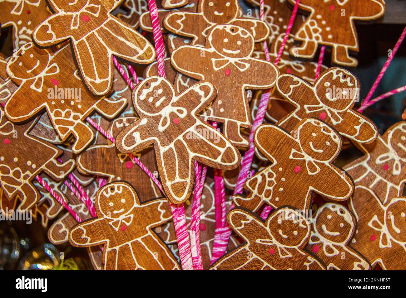 Holiday background - wooden gingerbread men on candycane sticks all piled up on each other - selective focus on foreground with som bokeh Stock Photo