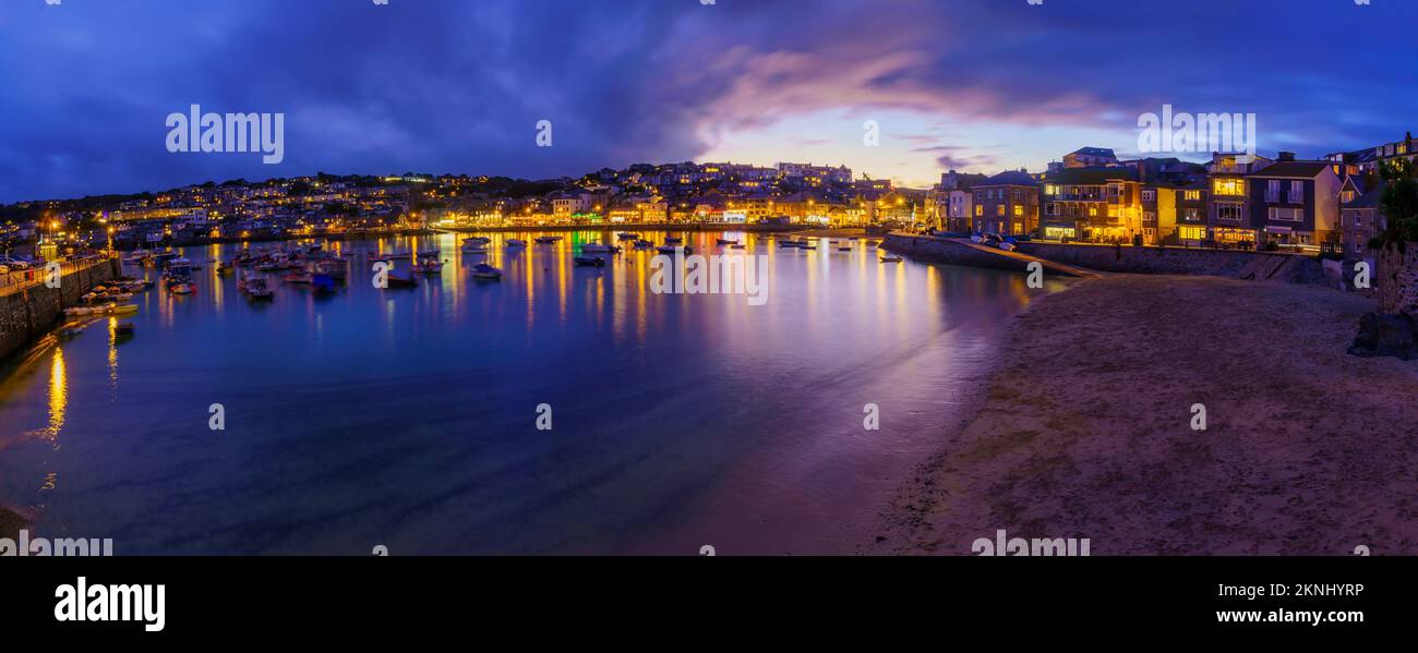 St Ives, UK - October 14, 2022: Panoramic evening view of the harbor, with various businesses, in St Ives, Cornwall, England, UK Stock Photo