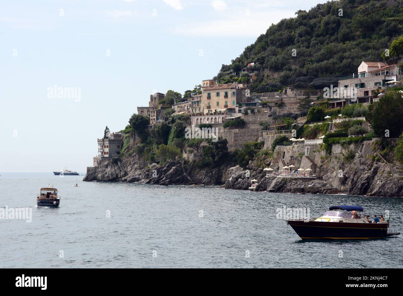 Boaters along the scenic and rocky stretch of the Amalfi Coast in the village of Marmorata, a hamlet of Ravello, in Campania, in Southern Italy. Stock Photo