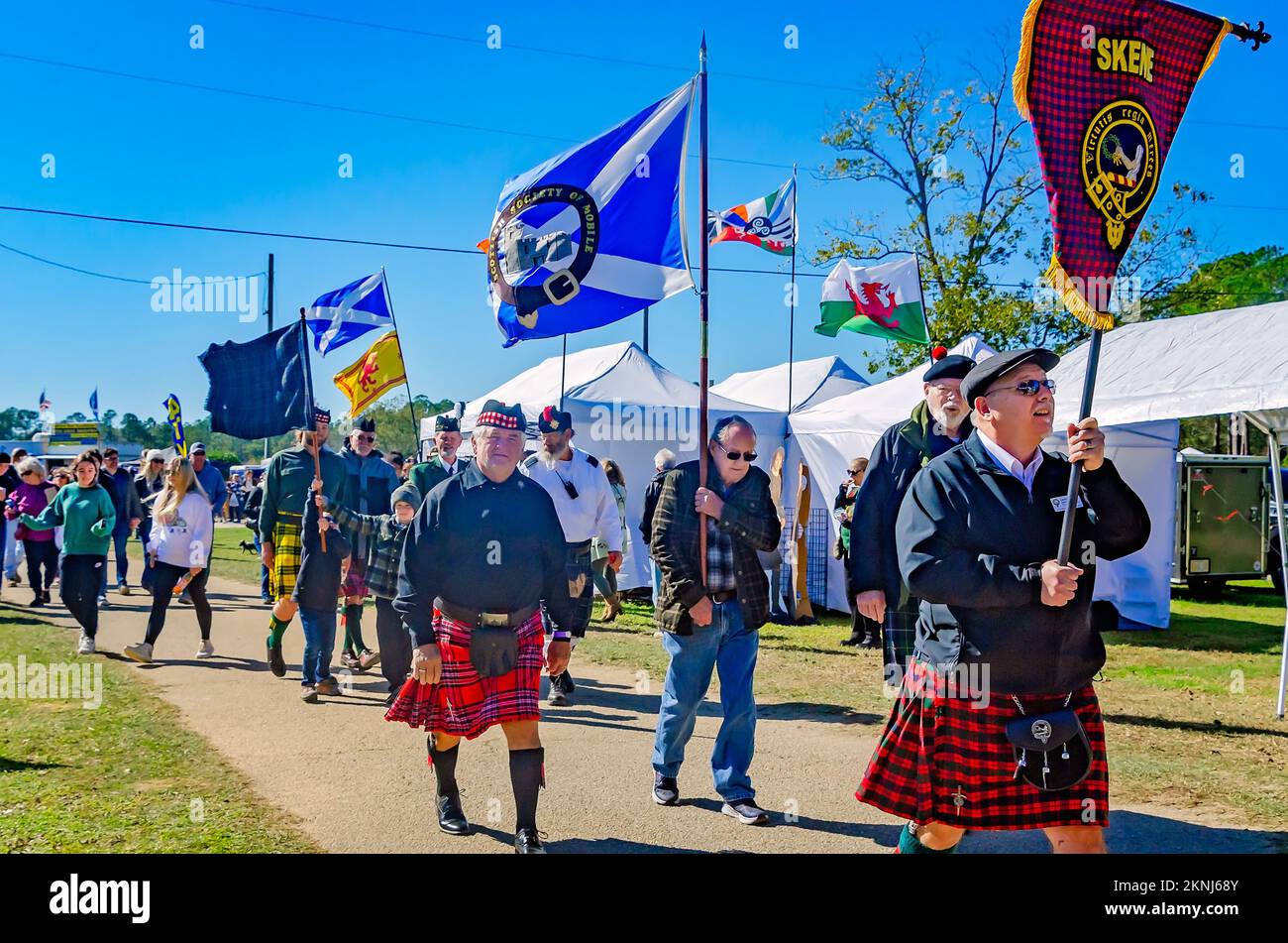 People carry tartan banners during the parade of clan tartans at the annual Celtic Music Festival and Scottish Highland Games in Gulfport, Mississippi. Stock Photo