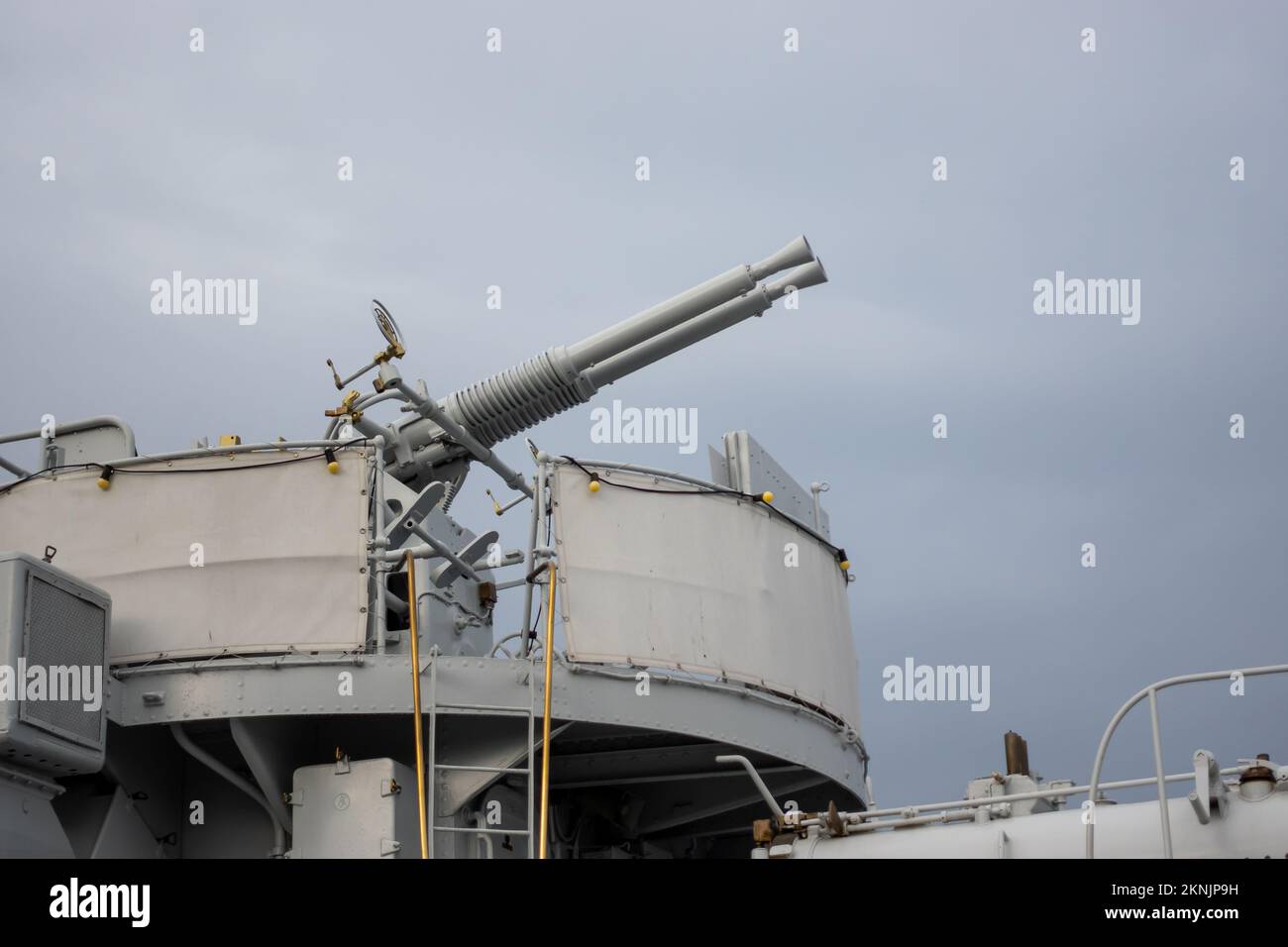 A double-barreled anti-aircraft gun on a historic warship. Photo taken on a cloudy day, soft light Stock Photo