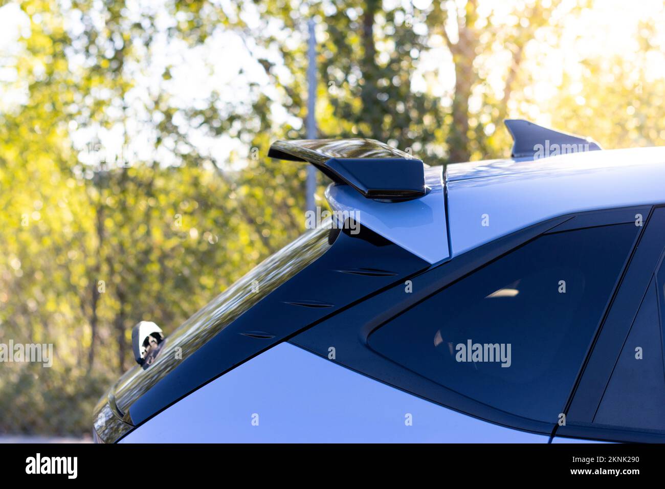 A custom racing carbon fiber spoiler on the rear of a modern car Stock Photo
