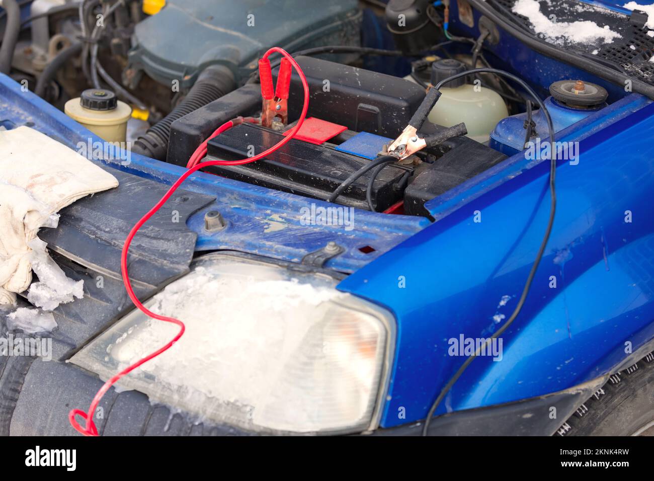 Connecting high voltage wires to the car battery. Charging automobile