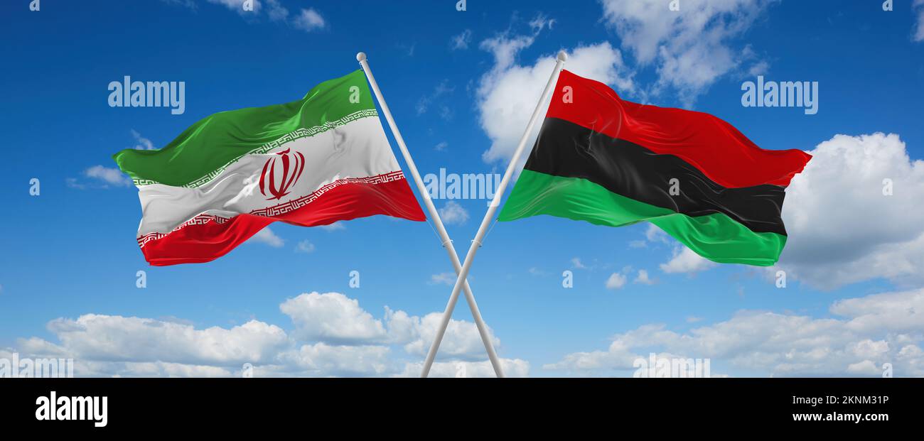 two crossed flags Pan-African and Iran waving in wind at cloudy sky ...