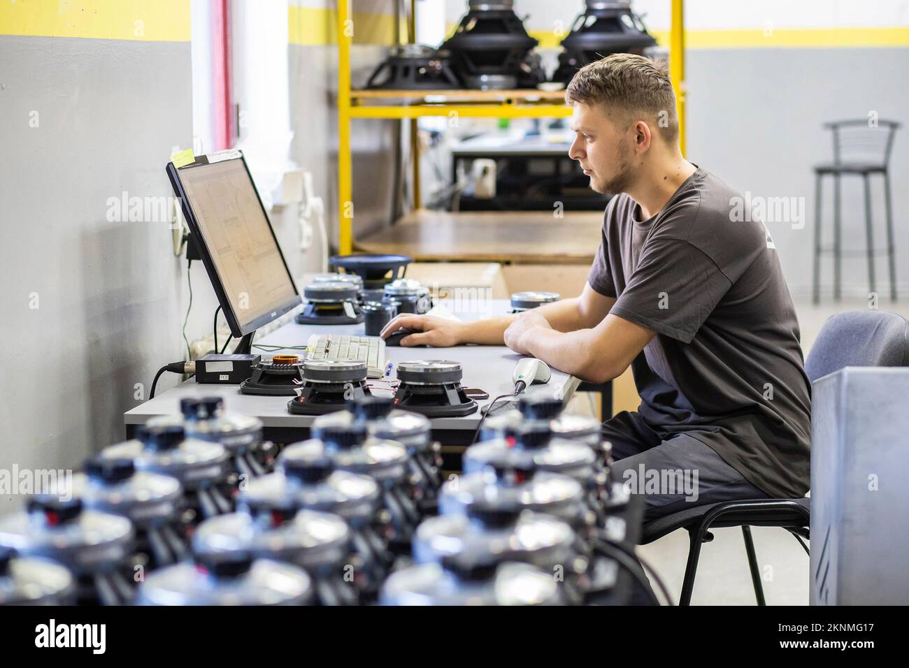 worker testing audio speaker at factory Stock Photo