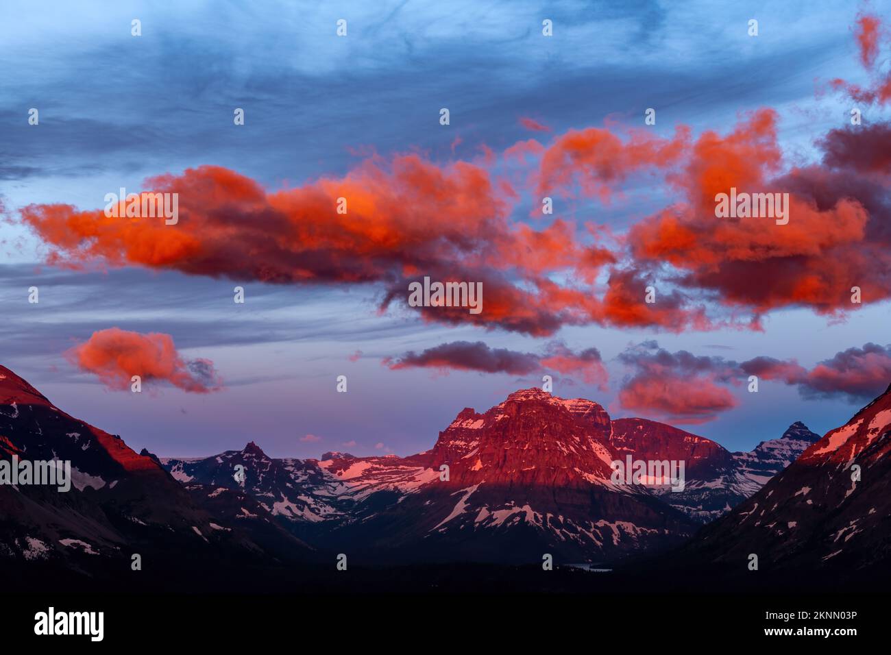 View of Glacier Park Mountain peaks at sunrise Stock Photo - Alamy