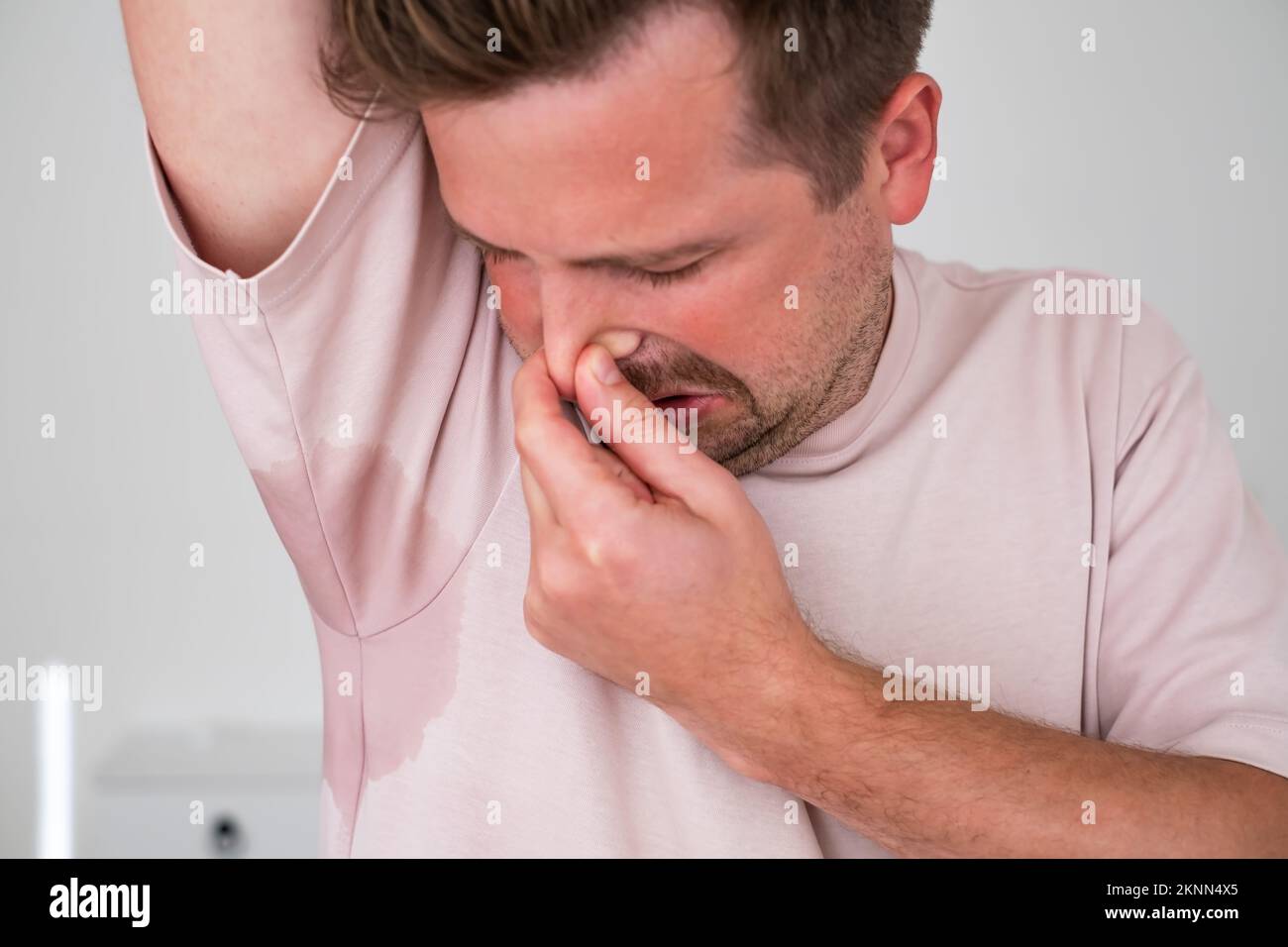 Man with hyperhidrosis sweating very badly under armpit Stock Photo - Alamy
