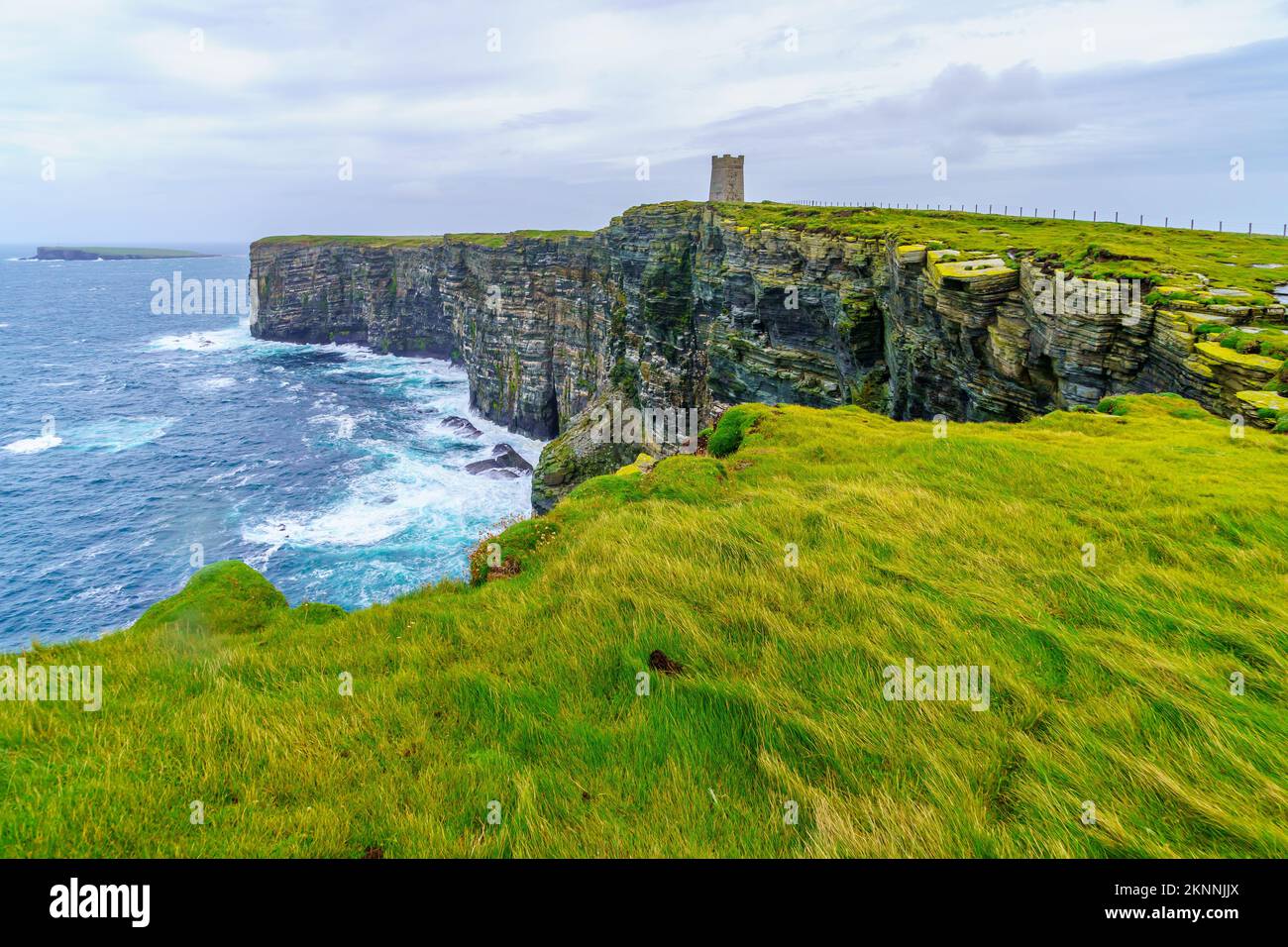 View of coastal cliffs and the Kitchener Memorial, in Marwick Head, Mainland Orkney, Scotland, UK Stock Photo